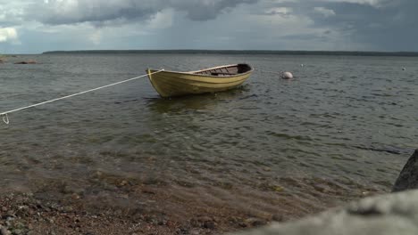 Vessel-in-shallows-of-Käsmu-Bay-tied-onto-shore,-bad-weather-approaching,-Baltic-Sea,-Estonia