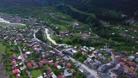 Aerial-shot-of-Mestia-township-in-Caucasus-Mountains-valley,-Georgia,-4K-view