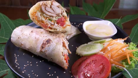 Chicken-Kebab-Wrap-on-a-Black-Plate-Close-Up-Spinning