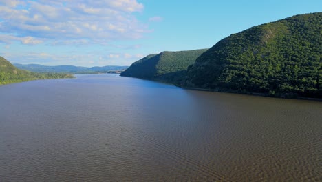 Aerial-drone-video-footage-of-summer-over-the-Hudson-River-valley-in-the-Hudson-Highlands-with-fluffy-clouds-and-and-blue-skies