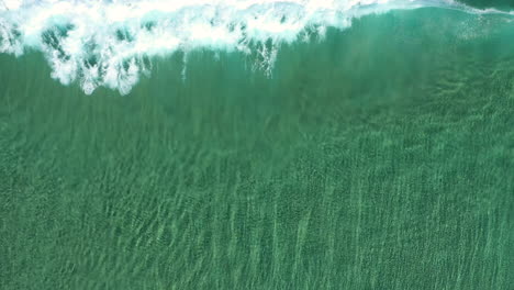 4k-Top-view-drone-shot-of-crystal-clear-turquoise-sea-ocean-and-wave-break