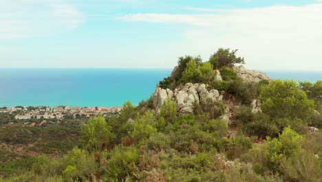Rocky-Mountain-Overlooking-Bright-Blue-Mediterranean-Sea-On-A-Sunny-Summer-Day