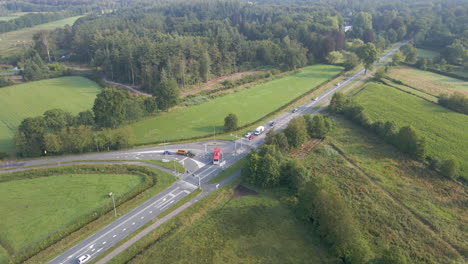 Aerial-of-bus-driving-over-road-in-rural-Holland