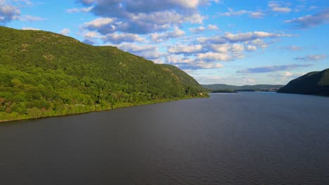 Aerial-drone-video-footage-of-summer-over-the-Hudson-River-valley-in-the-Hudson-Highlands-with-fluffy-clouds-and-and-blue-skies