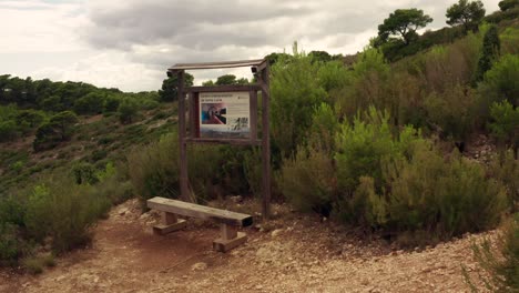 Wooden-Chair-In-Front-Of-Hiking-Sign-Trail-For-Taking-Picture-Spot