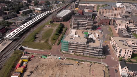 Aerial-view-of-Noorderhaven-neighbourhood-revealing-Ubuntuplein-construction-site-next-to-train-tracks-in-urban-development-real-estate-investment-project