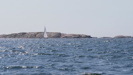 A-Sailing-Boat-Out-To-Sea-During-Summer-In-Bohuslan,-Sweden