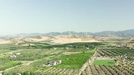 Panoramic-view-of-the-Calabria-coastline,-olives-fields,agricultural-fields-and-wind-turbines-in-the-background,-Calabria,-Italy