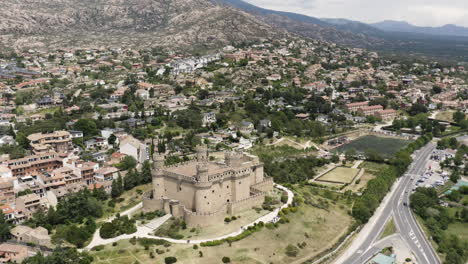 Wide-aerial-pull-out-view-over-the-Castle-Mendoza-and-the-surrounding-landscapes-of-Manzanares-El-Real-Spain