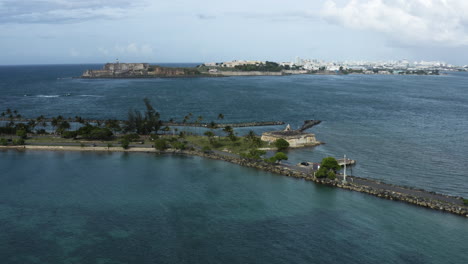 Wide-aerial-push-in-shot-to-the-old-fort-on-Isla-de-Cabra-on-Puerto-Rico---a-popular-tourist-destination