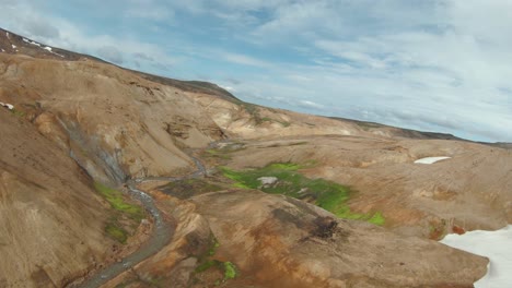 FPV-drone-shot-in-Kerlingarfjöll-volcanic-valley,-orange-mineral-surface