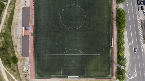 Birdseye-aerial-over-a-soccer-pitch-in-Spain-during-a-friendly-local-game-on-a-Sunday-afternoon---the-most-popular-sport-in-the-world