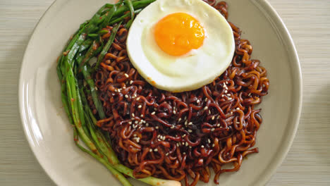 Homemade-dried-Korean-spicy-black-sauce-instant-noodles-with-fried-egg-and-kimchi