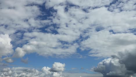 Dramatic-slow-cumulus-cloud-formations-coming-up-passing-by-and-diminishing