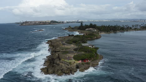 Push-in-aerial-over-the-former-fortifications-and-leper-colony-of-Isla-de-Cabra,-Puerto-Rico