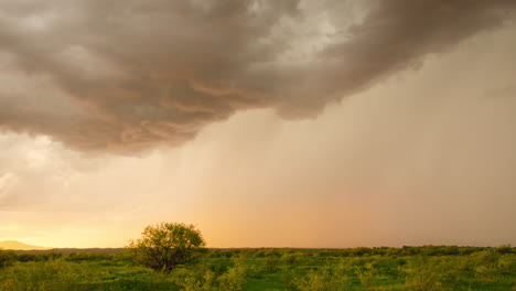 Monsoon-clouds-and-rain-over-landscape-at-sunset