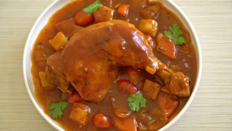 homemade-chicken-stew-with-tomatoes,-onions,-carrot-and-potatoes-on-plate-with-rice
