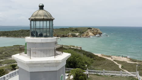 Close-fly-past-over-the-gallery-of-the-Faro-Morrillos-de-Cabo-Rojo-in-Puerto-Rico-looking-out-over-the-Caribbean