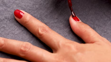 Woman-Painting-Nails-with-Red-Nail-Polish