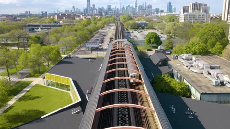 Subway-Train-Departing-Modern-Station,-Chicago-Skyline-in-Background
