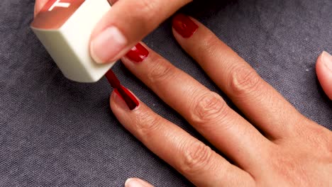 Woman-Painting-Her-Nails-with-Red-Nail-Polish