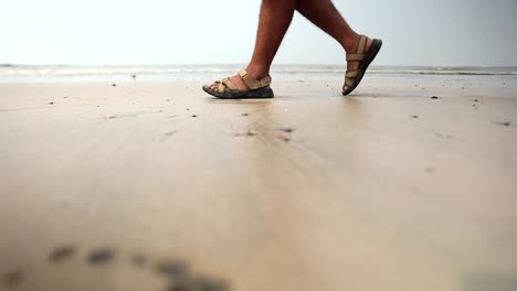 indian-boy-walking-profile-on-beach-sand-in-snadal-closeup