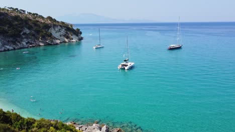 Catamaran-And-Sailboats-Anchored-Near-Navagio-Beach---Shipwreck-Beach-In-Zakynthos,-Ionian-Islands,-Greece
