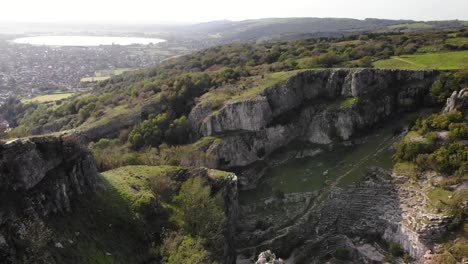 Aerial-Over-Adult-Male-Standing-At-Edge-Of-Cliff-At-Cheddar-Gorge