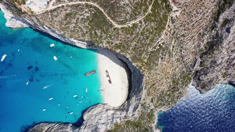 Aerial-View-Of-Boats-In-Navagio-Beach---Shipwreck-Beach-In-Zakynthos,-Ionian-Islands-Of-Greece
