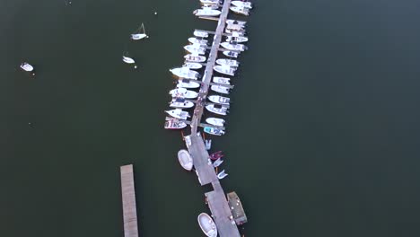 Birds-eye-aerial-drone-shot-over-Hingham-Harbor-Docks-and-Boats-,-Static-drone-footage-of-people-dancing-and-partying
