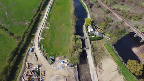 Aerial-flight-over-constructions-site-on-a-canal-lock-in-the-north-of-England