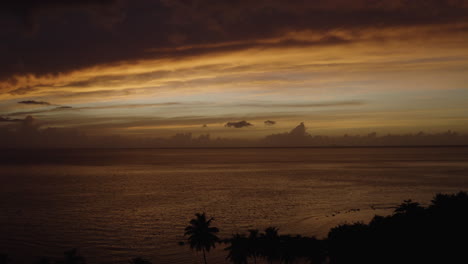 Filmischer-Flugauszug-über-Ostiones-Beach-In-Puerto-Rico---Wunderschöner-Karibischer-Ozean-Und-Silhouettierte-Palmen