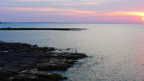 Person-Standing-Near-Rocky-Nightcliff-Foreshore-At-Sunset-In-Darwin-City,-Northern-Territory,-Australia