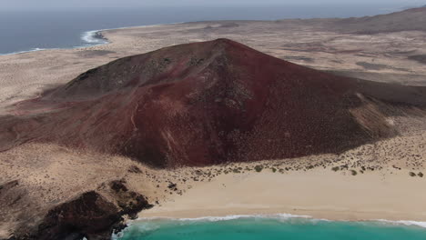 Rotating-drone-shot-of-the-mountain-of-Playa-de-las-Conchas-on-the-La-Graciosa-island-near-Lanzarote,-Spain