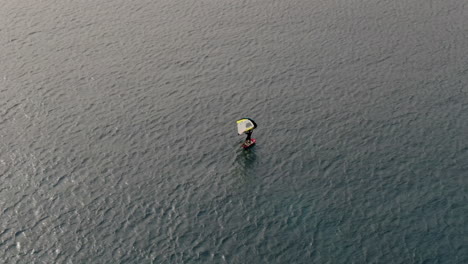 drone-shot-of-man-doing-windsurfing-in-the-sea