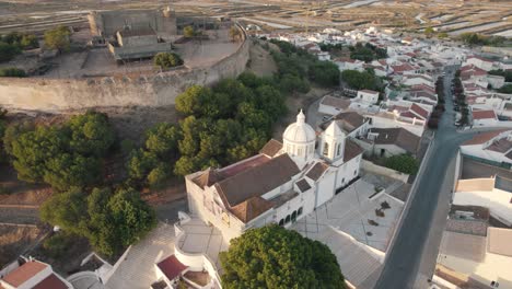 Aerial-pan-left-shot-of-famous-parish-Church-of-Our-Lady-of-Martyrs-in-Castro-Marim-Algarve-Portugal