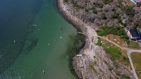 Aerial-View-Of-The-Rocky-Coastline-And-Blue-Ocean-Of-Asa-Beach-In-Southern-Gothenburg-In-Halland,-Sweden