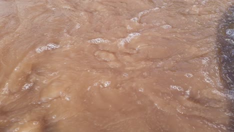 Aerial-view-of-the-dirty-river-with-muddy-water-in-the-flooding-period-during-heavy-rains-in-spring