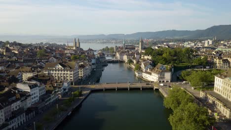 Drone-Flying-Above-Limmat-River-in-Zurich,-Switzerland-on-Gorgeous-Summer-Day