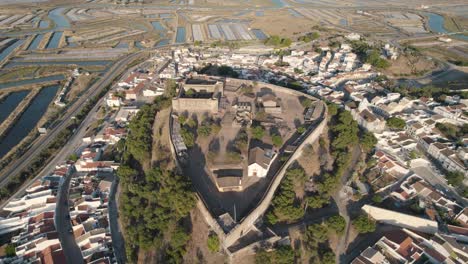 Descending-aerial-shot-with-point-of-interest-on-the-medieval-castle-in-Castro-Marim,-Portugal,-panoramic-view-for-a-great-sunny-day