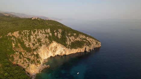 Beautiful-bay-surrounded-by-rocky-slopes-and-green-vegetation-washed-by-turquoise-sea-water-in-Albania