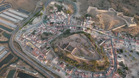 Bird's-eye-view-of-hilltop-Castro-Marim-Castle-and-surrounding-sprawling-town,-Algarve