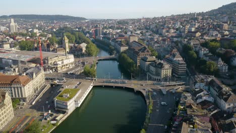 Buses-in-Zurich,-Switzerland-Cross-Bridge-over-the-Limmat-River-during-Morning-Commute