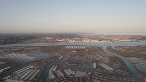 Dolly-out-aerial-shot-of-vast-expanse-of-salt-field-flowing-from-Leziria-estuary-natural-reserve