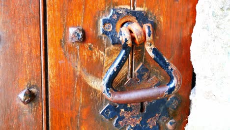 Heavy-wood-plank-weathered-medieval-door-with-metal-stud-nail-lock-and-handle-dolly-right-closeup