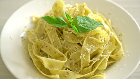 pesto-fettuccine-pasta-with-parmesan-cheese-on-top---Italian-food-style