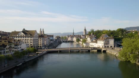 Low-Aerial-Flight-Above-Limmat-River-in-Zurich,-Switzerland-on-Summer-Morning
