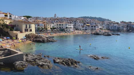Beach-in-costa-brava-Calella-de-Palafrugell-Tamariu-Catalunya-Spain-fishing-village-Mediterranean-sea-transparent-turquoise-blue-waters-Paddle-Surf-to-the-beach