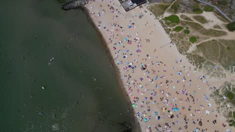 Top-Down-View-Of-Crowded-Beach-During-Summer-Holiday-In-Åsa,-South-of-Gothenburg,-Halland,-Sweden---drone-shot