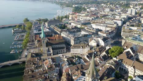 Establishing-Shot-of-Zurich,-Switzerland---Above-Church-of-St-Peter-and-Fraümunster-Church